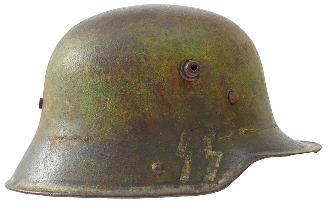 A FIRST AND SECOND WAR GERMAN M1916 HELMET,: A FIRST AND SECOND WAR GERMAN M1916 HELMET, the steel skull with traces of green painted base coat, later faded white painted border with SS insignia, leather liner.