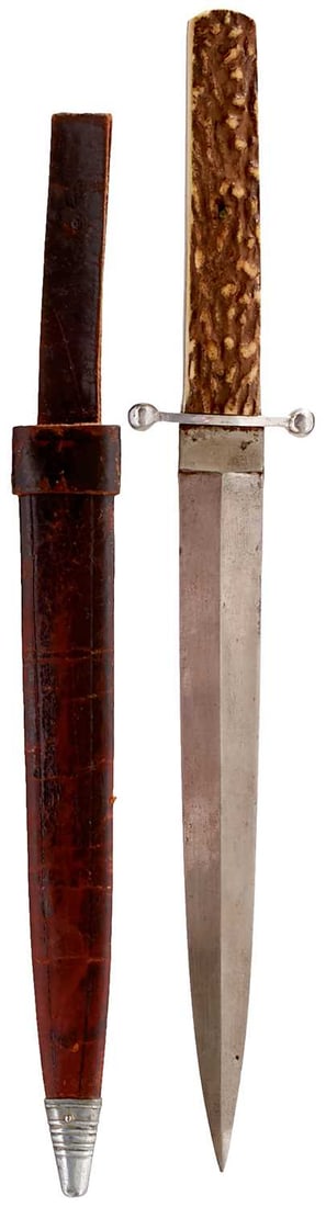 AN INDIAN BOWIE OR HUNTING KNIFE,: AN INDIAN BOWIE OR HUNTING KNIFE, 21cm flattened diamond section blade, characteristic hilt with plated shaped crossguard, two-piece natural stag's horn grips, in its tooled leather scabbard with embo