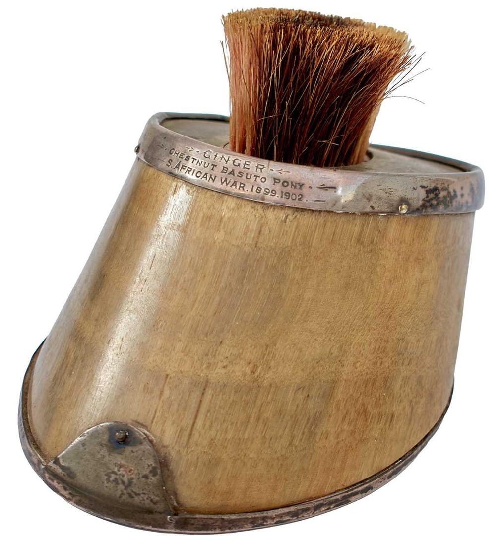 OF SECOND BOER WAR INTEREST: A SILVER MOUNTED HORSE'S HOOF BOOT BRUSH,: OF SECOND BOER WAR INTEREST: A SILVER MOUNTED HORSE'S HOOF BOOT BRUSH, the brass inset top fitted with a horse hair brush, the silver top mount inscribed GINGER, CHESTNUT BASUTO PONY, S. AFRICAN WAR 1