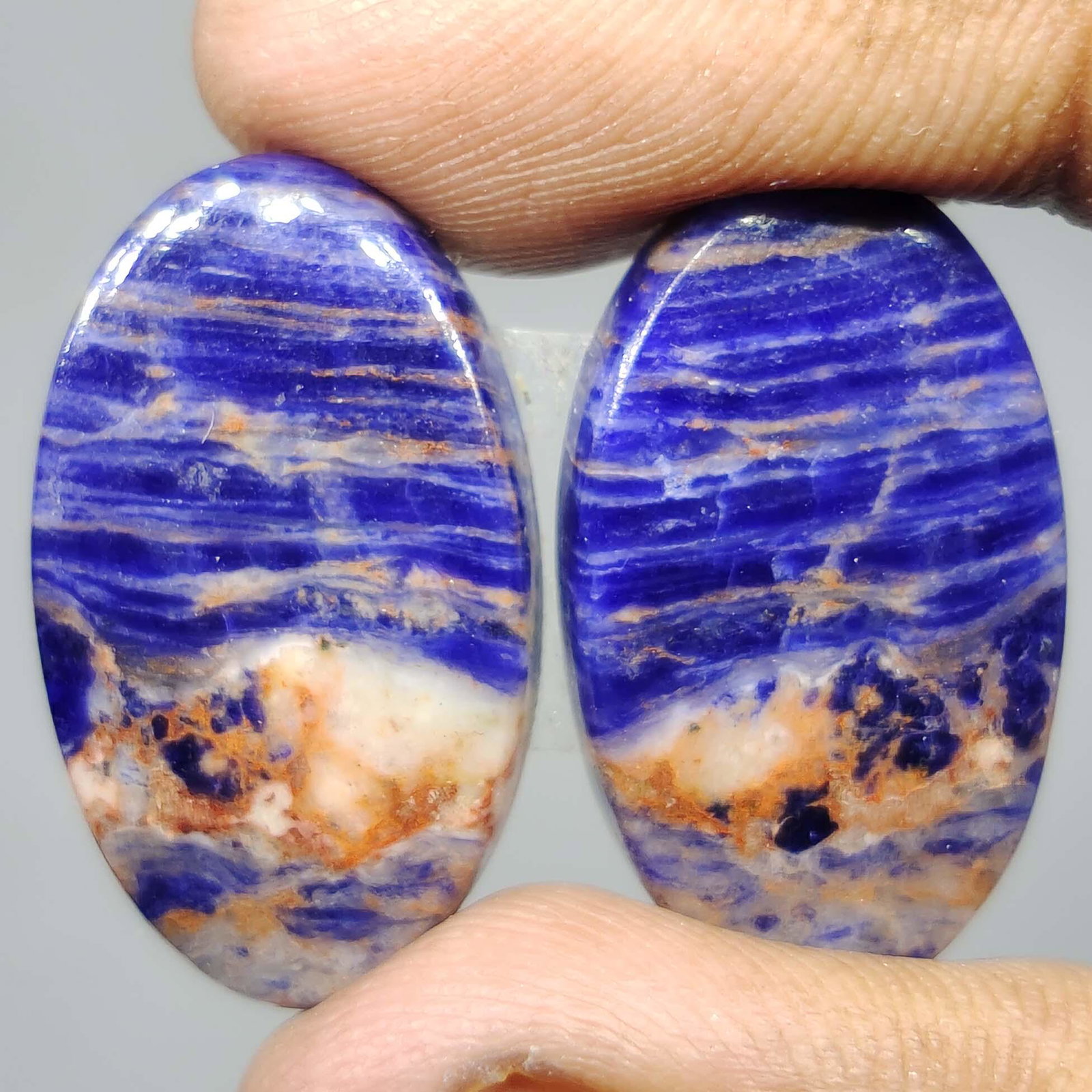 28.65 ct Natural Sodalite Pair: All the stones listed are 100% natural and rarely selected from a big quantity lot also these are of very high quality. BID WITH CONFIDENCE!!! DIMENSIONS : 24X14X4 mm