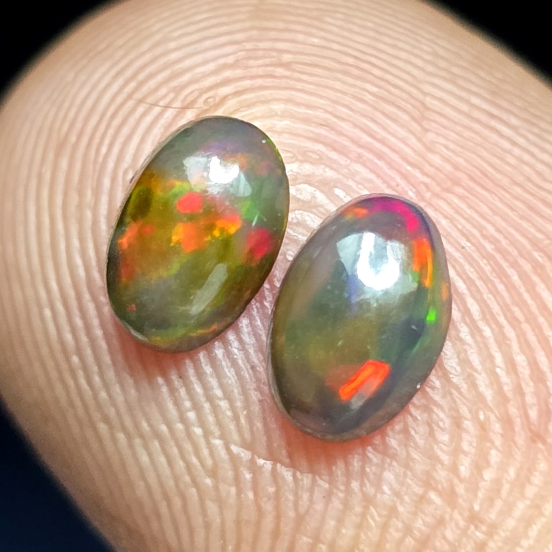 0.59 Ct "Play Of Colors" Natural Black Opal Pair: Gemstones: Natural Black Fire Opal /Carat Weights: 0.59 ct /Size or Dimensions: 6 X 4 X 2.40 mm /Treatment: Heated