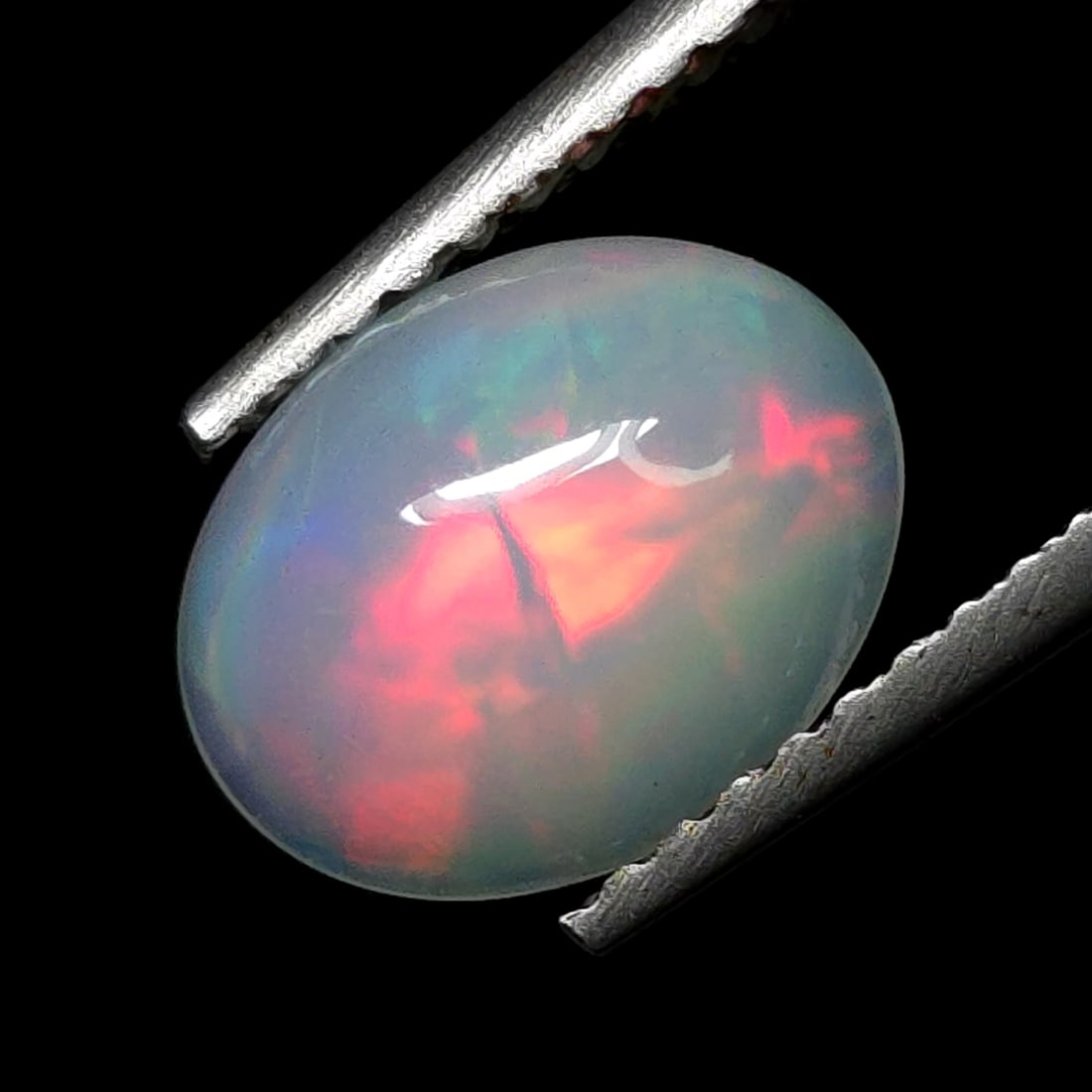 0.94 Ct "Play of Colors" Natural Ethiopian Fire Opal: Gemstones: Natural Fire Opal /Carat Weights: 0.94 ct /Size or Dimensions: 9 X 7 mm /Treatment: No