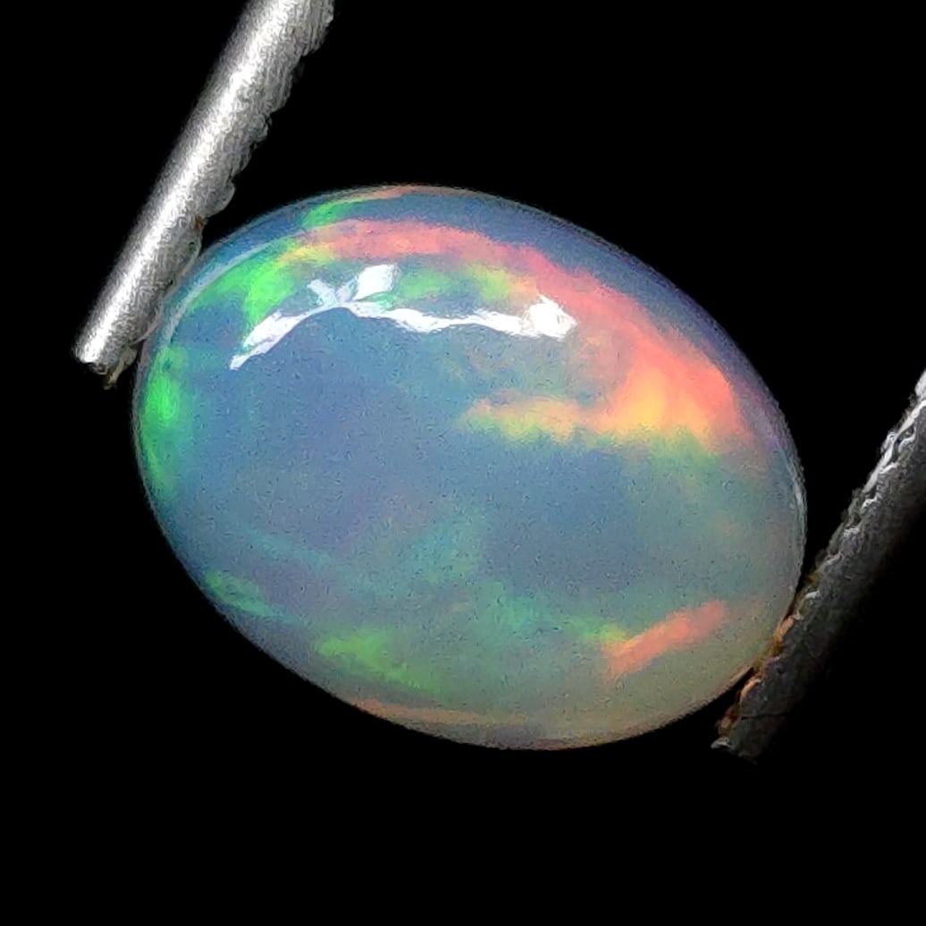 0.83 Ct "Play of Colors" Natural Ethiopian Fire Opal: Gemstones: Natural Fire Opal /Carat Weights: 0.83 ct /Size or Dimensions: 8 X 6 X 3 mm /Treatment: No