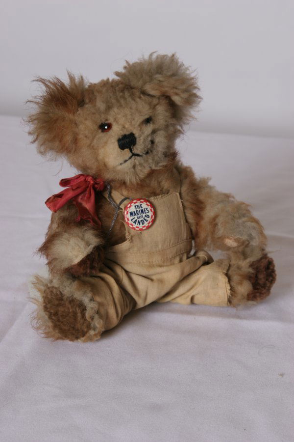 Teddy Bear: Very Old with Glass Eyes and Dressed i: Teddy Bear: Very Old with Glass Eyes and Dressed in Cloth Overalls wearing a Button. "The Marines Have Landed". Size: 10" H.