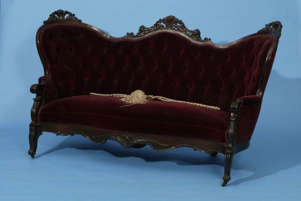 Circa 1860 Rosewood Rococo Revival Sofa: 3 deeply carved and pierced rose pattern crest, tufted back with later burgundy velvet coverings, 76" L x 40" H x 34" D.