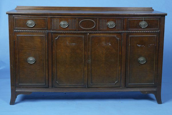 Circa 1948 Walnut Duncan Phyfe Buffet: Reeded decorations, splay feet, 3 drawers including flatware drawer over 4 doors, 58" L x 19" D x 36" H.