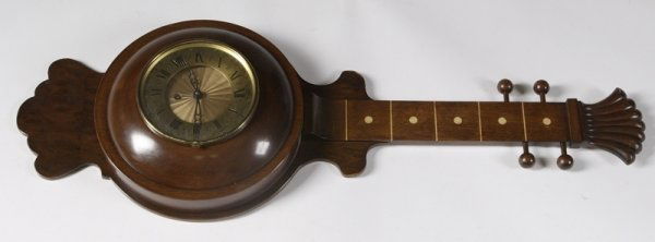 Unique 20th C. Sitar Wall Clock: Walnut finish with Roman numeral dial and carved shell form headstock along with marquetry inlaid frets, 27" H. Minor surface scratches, not tested for working condition.