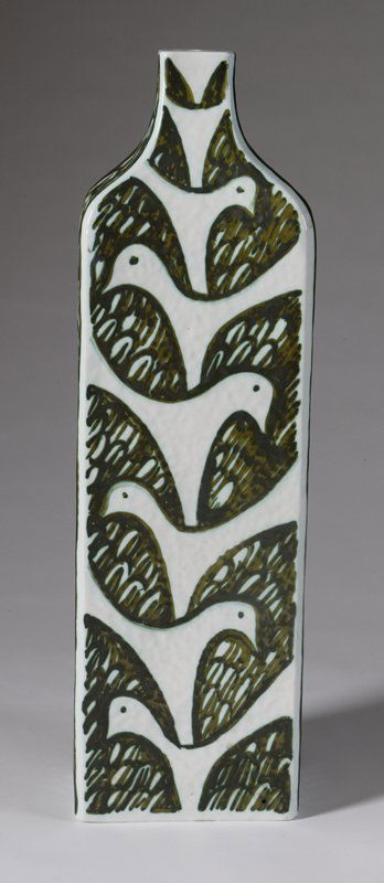 20th C. Raymor Italian Pottery Table Lamp Base: Tall rectangular form with stylized dove and fish decorations, signed underneath, 27" H x 8" W x 5" D. Condition: 1/4" diameter glaze chip on the shoulder of the item, no other damage found.