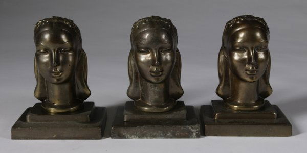 C/1930s - 3 Frankart Figural Spelter Bookends: All brass plated, all modeled as young female heads, all measure 6-1/4" H and all are signed underneath. One with some light corrosion, all with minor wear.