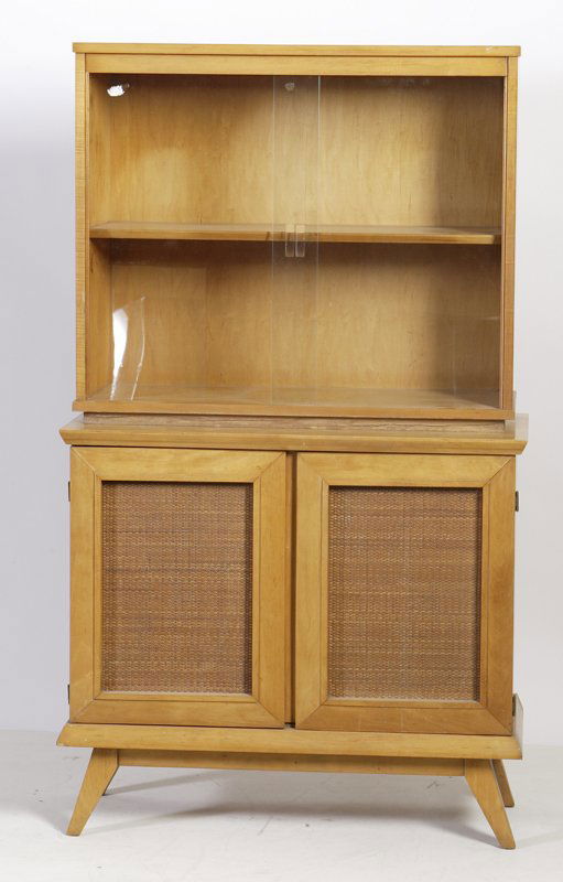 Conant Ball China Cabinet by Russel Wright: Circa 1950's, glass sliding doors on top and 2 interior shelves over a cabinet with 2 cane door fronts and interior drawer raised 4 angular feet, 51.5" H x 36" W x 16" D. Few minor scratches on the ca