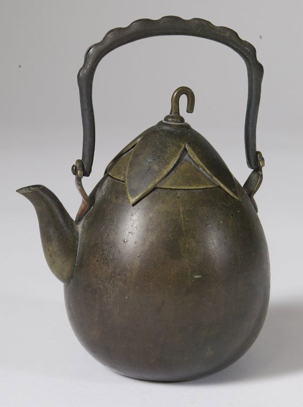 Rare 19th C. Middle Eastern Brass Teapot: Pear shaped with hammered leaf hooked top and copper hinged curved and fluted edged handle, 7" H. The pot is tarnished with surface scratches throughout from age and normal use.