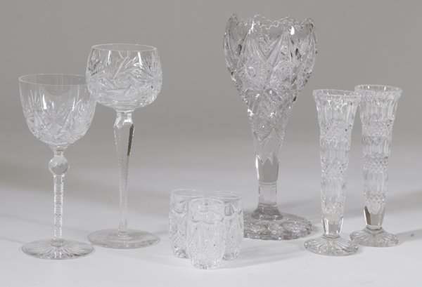 8 Pieces of Cut Glass: Including 2 cut to clear crystal wine glasses. A cut to clear glass vase with ruffled cut edges, 2 small bud vases, and 3 toothpick holders, largest item 9" H. Good condition.