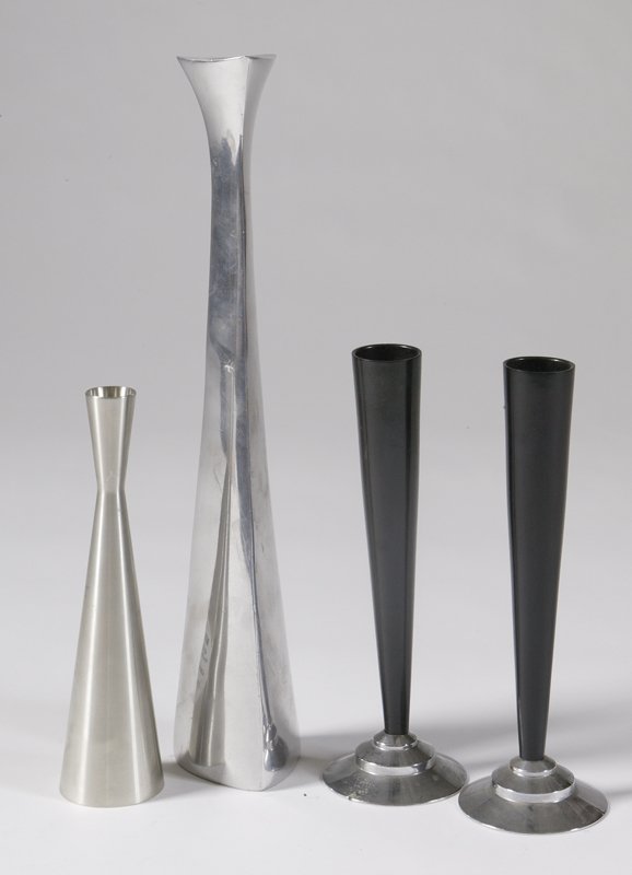 4 Pieces of Mixed Metal Contemporary Vases: Including a tall metal vase signed Nambe. A pair of Dura-Vases with black Bakelite flutes, and a pewter vase signed Selangor. Tallest item 14.5"H. There minor surface scratches throughout each vase an