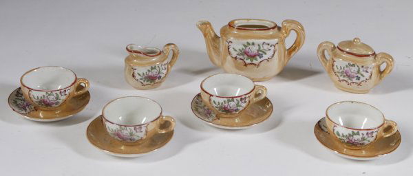 11 Piece Japanese Lusterware Child's Tea Set: In hand painted floral designs, includes 4 cups and saucers, creamer and covered sugar bowl, and teapot. The lid for the teapot is missing, otherwise good condition.