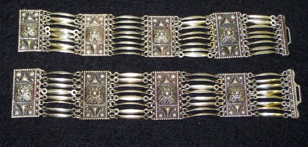 2 Mexican Silver Bracelets: Circa 1930's includes two wide link bracelets. Both with a hook clasp. Signed Made in Mexico, and Silver Mexico. One has been repaired and has approximately 9 brass pieces attached.
