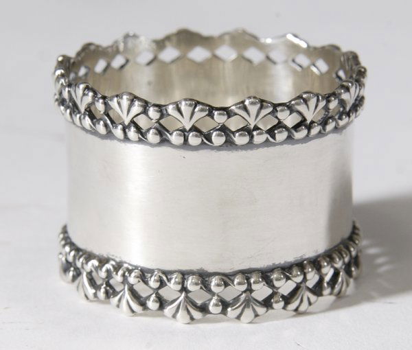 Early 20th C. Sterling Silver Napkin Ring Holder: Marked sterling 113 with molded leaf form borders on the top and bottom, 1.75"H. Excellent condition.