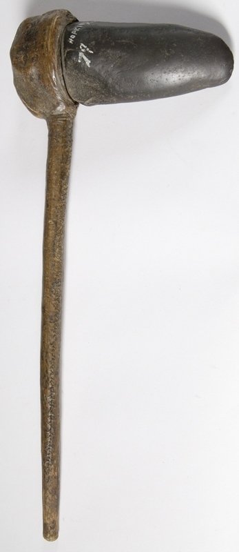 Ancient Stone Ax w/Original Hafting: Large stone ax head with unusual attachment treatment, appears to have great age, with collector attribution of Hopkins, MI, fully leather buckskin wrapping, approx. 20" L with the ax head being 8" L.