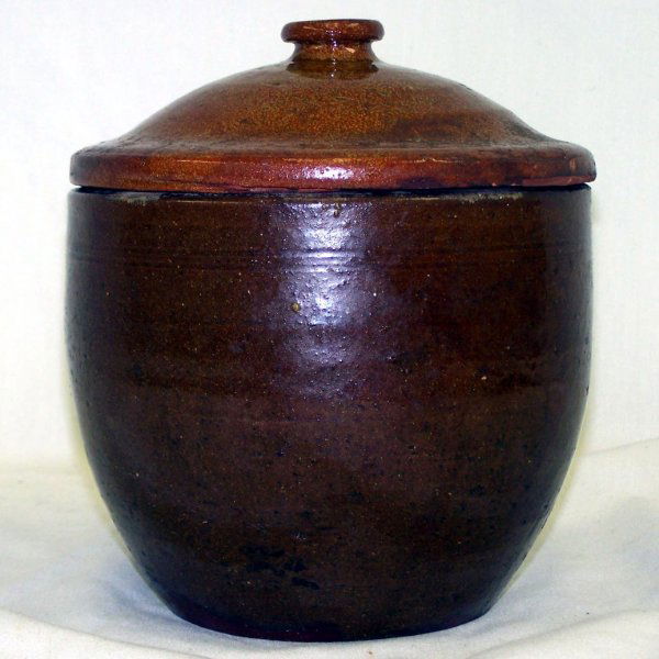 1830's Redware Pottery Covered Bean Pot: Possibly from Pennsylvania, pot is of classical redware in a honeycomb shape with lid. 8.5" H x 7" Dia. Some fleck chips and wear to edges.