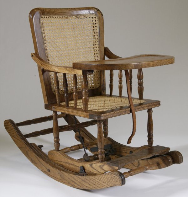 Wooden Childs Rocking / High Chair w/Eating Tray: Cane seat and back with oak construction, child's chair, lifts up. Condition: Excellent for its age and use.
