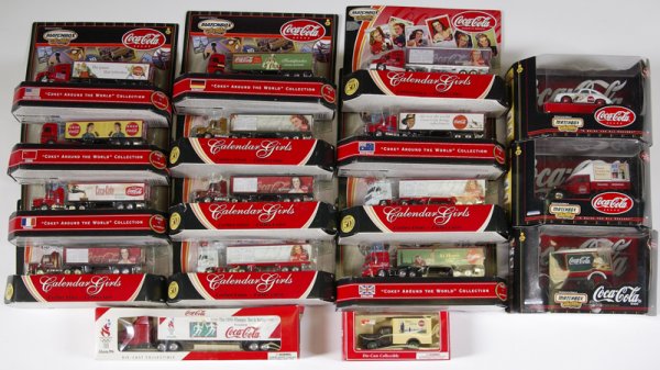 Lot of 17 Coca-Cola Vehicles in Boxes: To include a "1996 Olympic Torch Relay" semi-truck, 6 "Calendar Girls" semi-trucks, 6 "Coke Around the World" semi-trucks, 3 "Matchbox Collectibles" vehicles, and die-cast collectible delivery truck. 