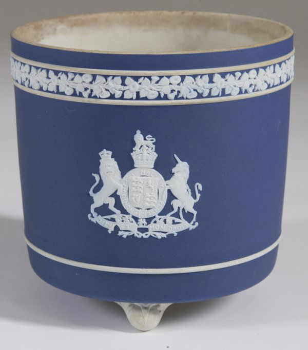 Wedgwood Blue Jasperware Sheild Cache Pot: Dark blue jasperware cache pot/jardiniere, with a base relief of a shield with a lion and horse. Stands on three feet. 6.25" H x 6.25" Dia. Three hairline cracks to interior with one extending to exte