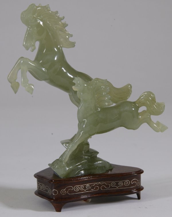 Jade Carved Horse Figures on Stand: Large carved horse rearing while a smaller young horse next to larger is bucking. Comes on rosewood with inlaid brass stand. 6" H; excellent condition. Private collection Ortonville, MI.