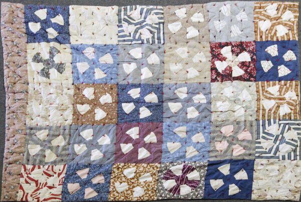 Early 20th C. Handmade Kaleidoscope Quilt: Hand sewn kaleidoscope block sections in mult-color. Back is red and blue checked material. Edges are machine sewn. 59" x 75"; minor wear to top.