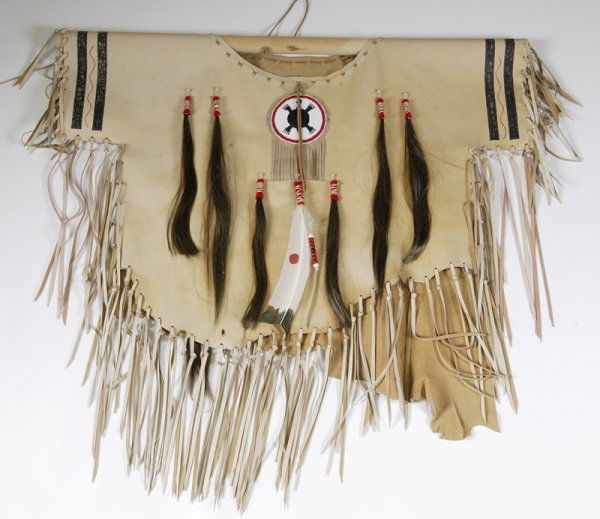20th C. Leather Scalp Shirt w/Hair & Bead Decorati: Leather scalp shirt with 8 human hair drops, fringe overall, circular beaded chest medallion (4" Diameter), turtle motif in white, red and black beads. One feather in front and back painted in abstrac