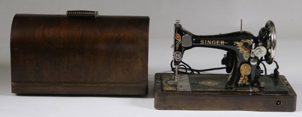Ornate Antique Portable Singer Sewing Machine: #AB199643. Black with gold lettering, machine shows signs of use. Cord attached and has fraying near the plug. Top wooden box and missing original key. Unknown as to working condition. Collection from
