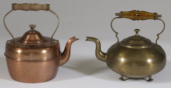 2 Tea Kettles; Copper and Brass: Includes an O.D.T. Made in Portugal copper tea kettle with brass and wood handle, 9" H. And a Birmingham brass tea kettle with blown amber glass handle, raised on four feet, 8.5" H. Great condition on