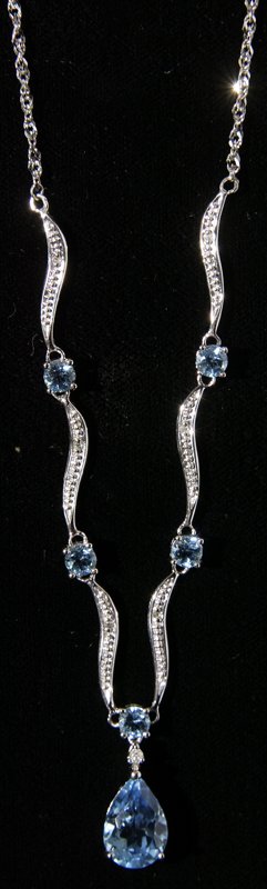 14K Gold, Diamond and Blue Topaz Necklace: 14K white gold with small diamonds and 6 blue topaz stones, with largest at bottom in teardrop shape; 5 ct. 19" L; great condition. Private collection San Diego, California.