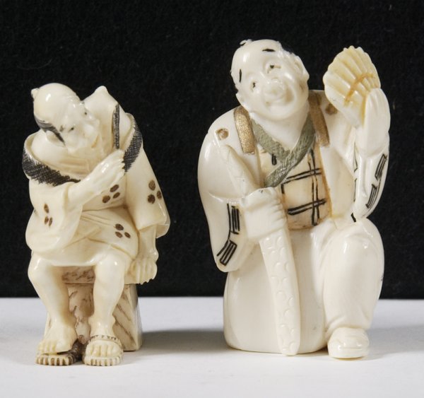 2 Ivory Netsuke's: 2 elders, one sitting holding a samurai sword fanning himself. Second elder appears to be playing a flute. Both hand painted and signed with Japanese characters, unknown to us. Collection of Dr. Roat,
