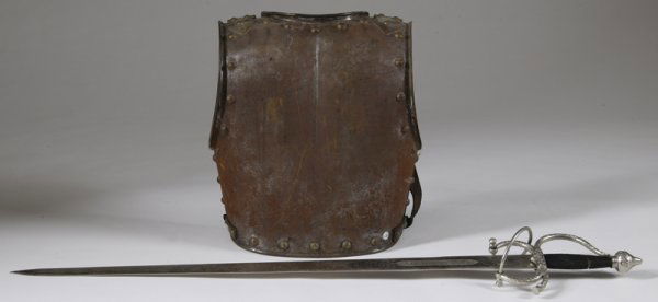 Medieval Sword and Breastplate: Toldeo sword with ornate desisngs with "Colada del Cid." Not sharp, measures 41" L. Together with an antique breastplate, probably English. Shoulder leather strap missing, as well as backplate. Leathe