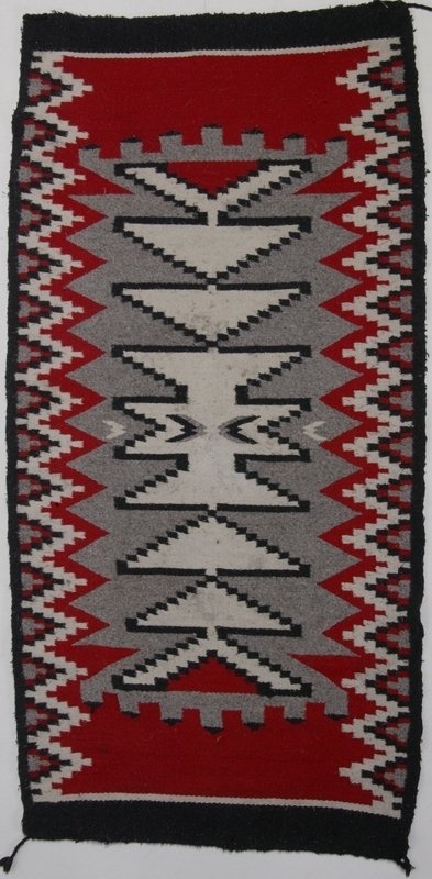Vintage Navajo Rug Wall Hanging: Geometric patterns in black, red, white and gray. 58" L x 29" W. Wear and minor staining consistent with age and use. Private collection Grand Rapids, Michigan.