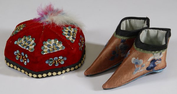 Chinese Silk Binding Shoes & Chinese Hat: Included is a pair of Chinese women's silk embroidered bound feet shoes along with a red velvet Chinese hat with hand sewn sequins and beads with feather top. Largest measures approx. 6.5" wide. Silk 