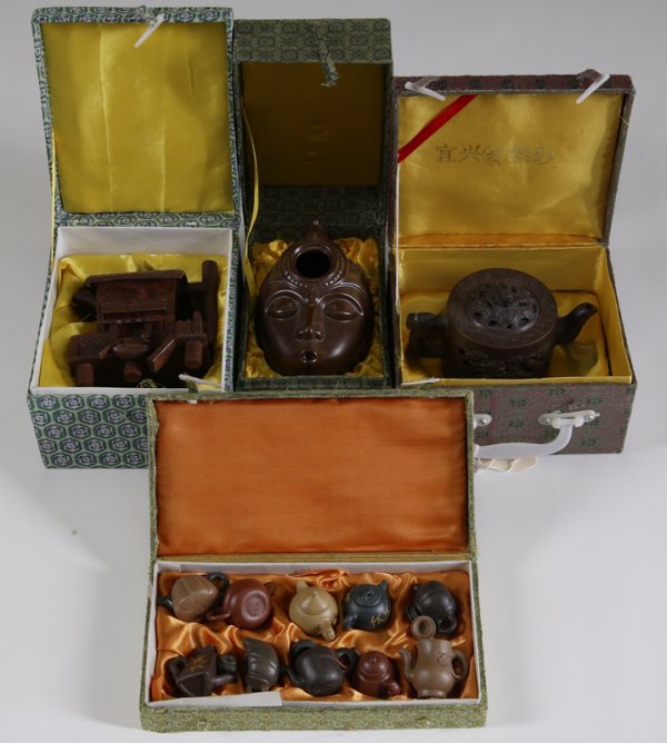 3 Boxed Chinese Tea Pots & Miniature Tea Pots: Includes a Tai Hua dragon tea pot, a face form tea pot, and a house form tea pot. Together with a box of 10 miniature tea pots in various styles. Two of the miniature pots have repaired handles, remai