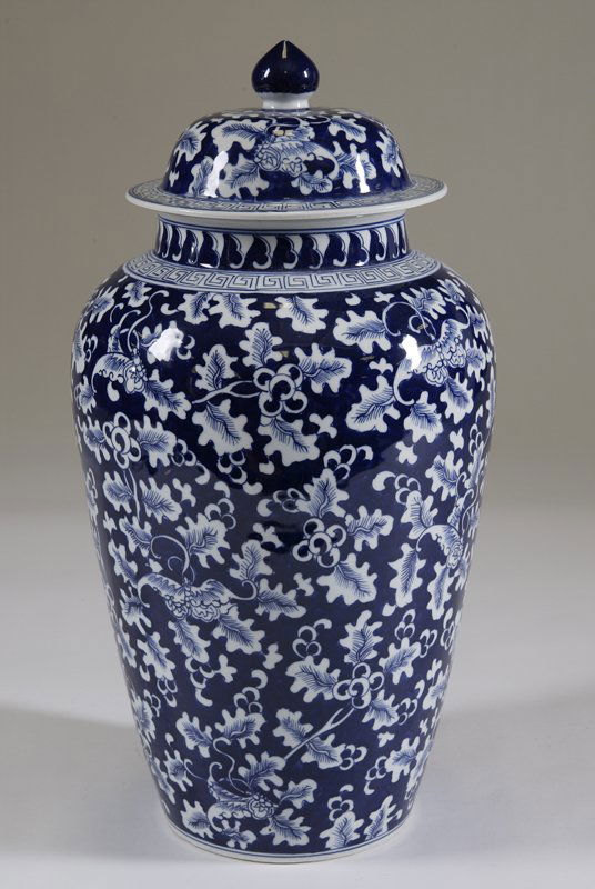 Large Chinese Blue and White Covered Ginger Jar: Porcelain ginger jar with hand painted blue and white leaf decorations. Greek key design on top of ginger jar and outer edge of lid. Measures approx. 19" including lid. Very good condition.