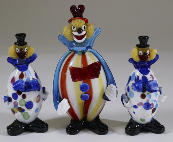 3 Vintage Murano Art Glass Clowns: Includes a small pair of clowns with blue bowties, and white and spotted/swirled outfits, 7.25" H. And a larger clown with striped outfit and big red bowtie, 9.5" H. Surface scratch to one of the pair