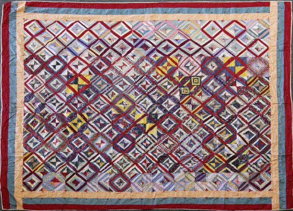Vintage Sampler Quilt: Quilt with multitude of colored sample pieces with red string tufts that form X on back. Peach, green and red border, and back is cream. 7' x 70"; some tears and staining. Estate of Meg Heinrich, Roch
