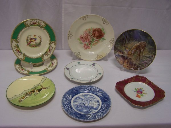 Lot of Seven Decorative Plates: Lot includes Woods & Sons The Grist Mill plate, Two Myotts Staffordshire England "Chelsea Bird" plates signed A. Roberts, Austria dog scene plate circa 1915 and more. Chip to outer edge of dog scene p