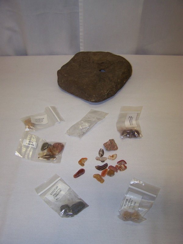 Large Lot of Stones: Featuring a large stone with hole in center and several small bags of stones from different regions such as Gypsum selenite rosette from Mexico, Specular Hematite Champion from Mi. Quartz crystals fro