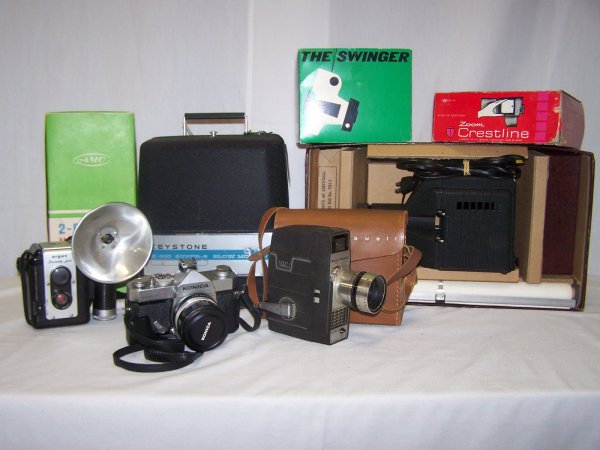 Large Camera Lot: Camera Lot includes a Bell & Howell camera with leather case, Konica 35 mm camera with case. The Swinger Polaroid land camera in original box and much more. Good used condition. Unknown working condit