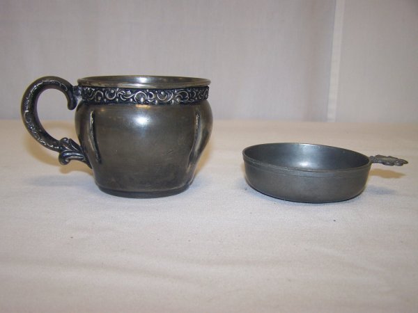 Two Piece Metal Lot: Lot includes decorative quadruple silver plate mug along with a signed small Dominique Rachez pewter dish with handle and decorated with soldier with armor on horse. Good used condition.