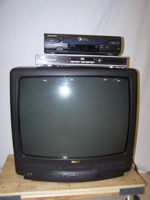 Four Piece Electronic Lot: 21" R C A and 25" G.E. colored televisions along with a Panasonic video player and a Polaroid dvd player. Good used condition.
