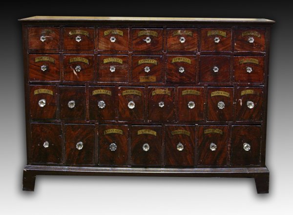 Exceptional 19th C. American Apothecary Cabinet: 29 drawers with exceptional grain painted surface to simulate flamed mahogany. Bracket base with nice cutouts. Glass drawer knobs. Top with molded base. Most drawers with spice or drug labels. 36" H x