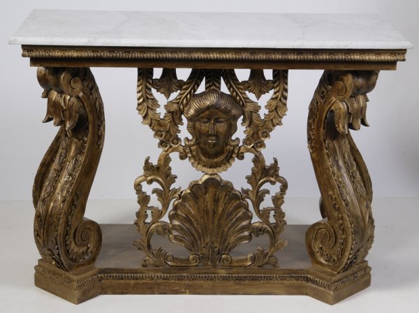 Very Fine Italian Carved Giltwood Console Table: Late 19th/Early 20th C. Four ornate rococo serpentine style columns with scroll carvings. Center face form above large seashell. Sides with carved swag on top of frieze, and on bottom smaller carved s