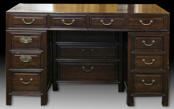 Exceptional Chinese Rosewood Paneled Desk, 19th C.: The uniquely designed rosewood desk has ten drawers and a center cabinet that sits underneath desk with three center drawers. Sides and back of desk are finely paneled. Beveled glass top and brass har