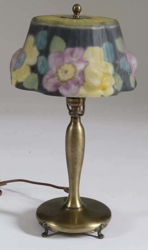 Antique Pairpoint Puffy Shade Boudoir Lamp: Reverse painted puffy floral shade in pink and yellow flowers with blue and greens. Base is style #3047 1/2, and is signed on bottom. Measures 16" H. 1" x 2/8" chip to rim of shade, wear to base. Priv