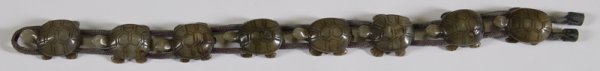 Exceptional Hand Carved Jade Turtle Bracelet: Eight identical carved jade turtles attached to two cords. Turtles move for correct size. Early to mid. 20th C. Brown stain added to highlight shell, eyes, toes. Each piece with signature on bottom. 1