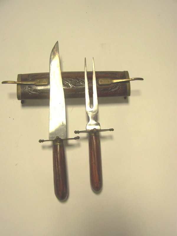 Wooden Cutlery Set: Carved wooden cutlery set has brass accents. Inserts on each end for fork and knife. Made in India. Measures approx.17.5" long. Good condition.